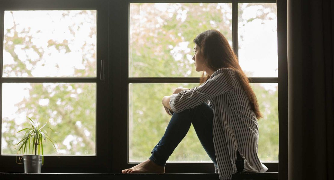 Woman Sitting in Window